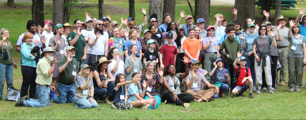 A large group of people pose for a photo outdoors at Camp Fletcher during the 2022 BioBlitz.