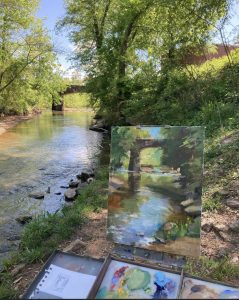 Photo of an oil painting on canvas in progress beside the Cahaba River. Amy Petersen paints the Cahaba River during Trussville Heritage Days. Photo by Gary Lloyd.